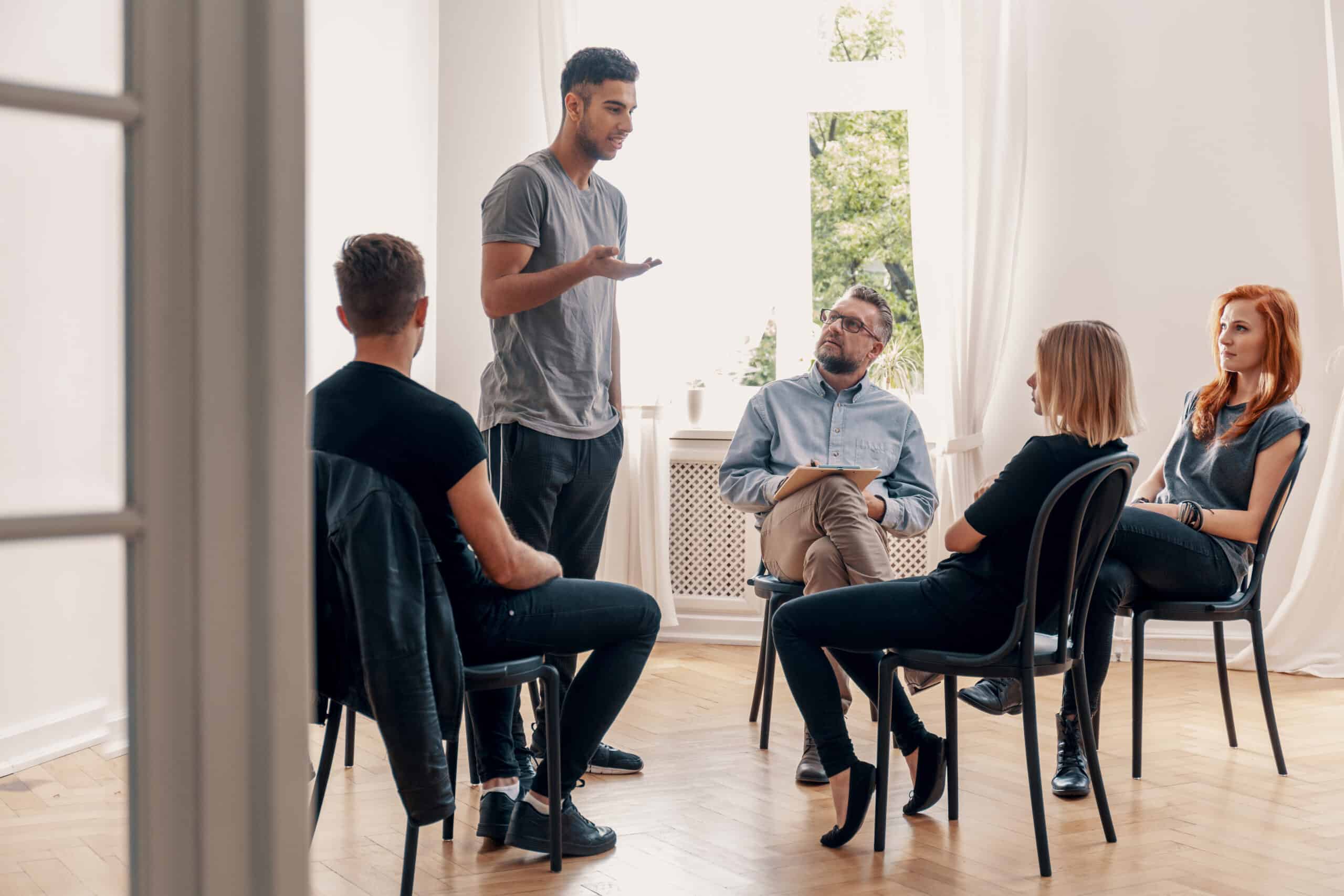 man talking during meeting of support group